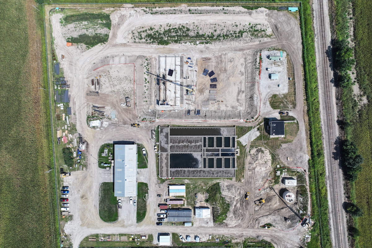 The large excavation is for the new Aeromod Treatment Basin. One of four slab pours is completed, with construction starting on the concrete walls. The round circular structure in the bottom right is the new influent pump station.