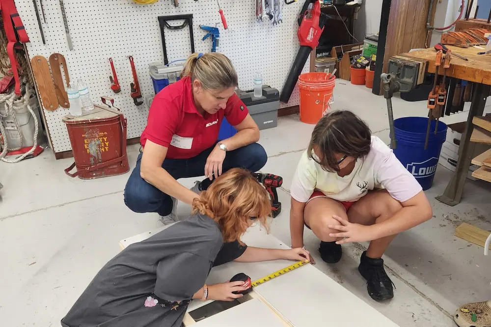 A Superior Construction employee teaching a hands-on learning session for middle school students in Indiana.