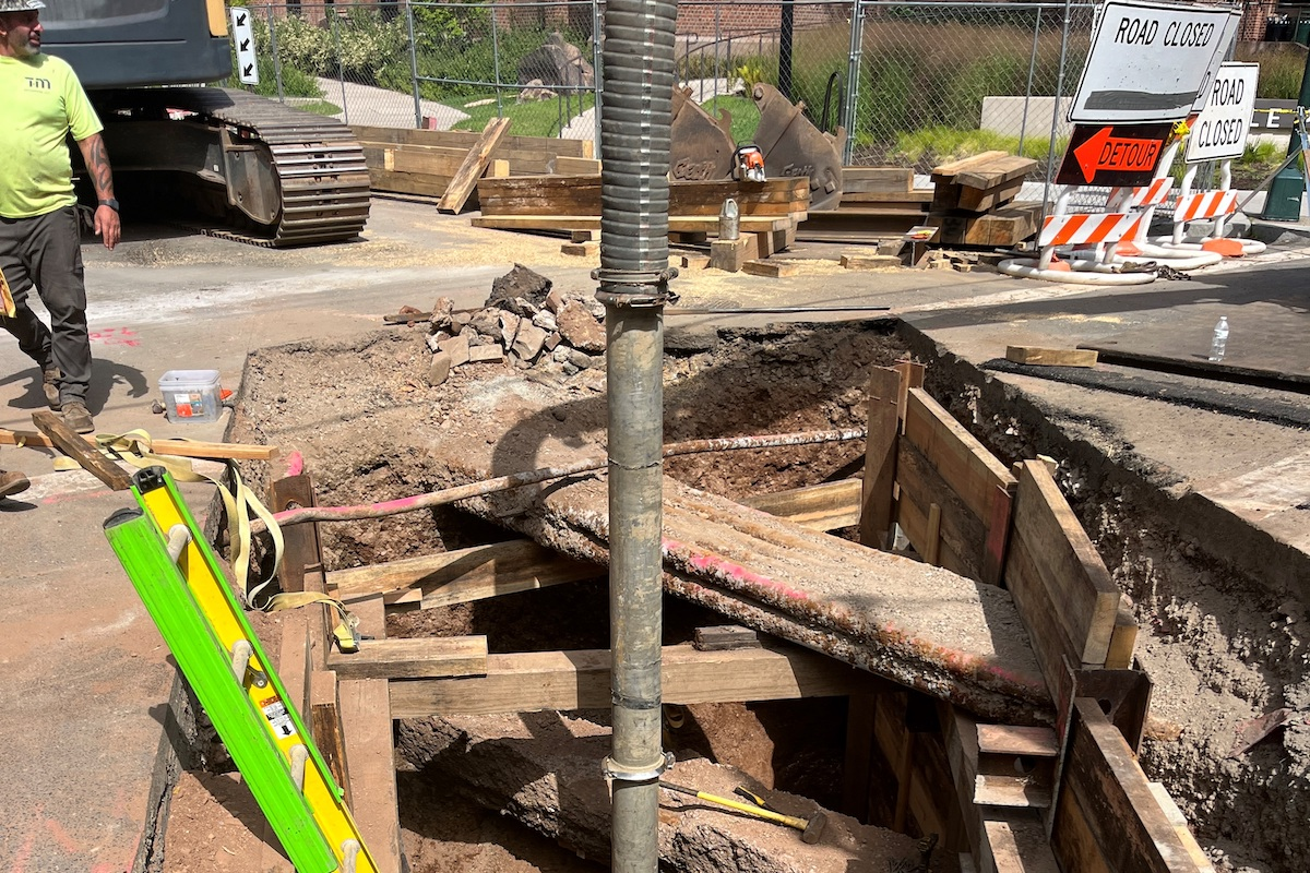 During the exploration stage, vacuum excavation is used to locate existing underground utilities to map and devise a support of excavation plan and means to support existing utilities, coupled with the task of opening the road nightly to four lanes of traffic.