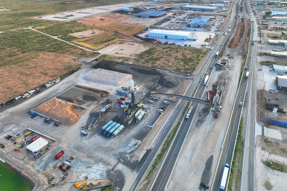 To deliver concrete while minimizing traffic disruptions, Sundt set up a concrete plant and installed a custom conveyor steel bridge structure across I-20.
