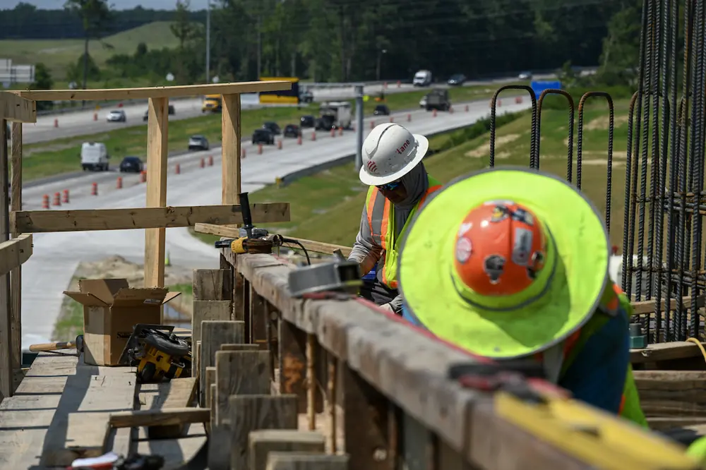 Contractors work on concrete form work at the I-77 Exit 26 overpass. This overpass will serve the new Scout Motors facility and connect motorists to U.S. 21.