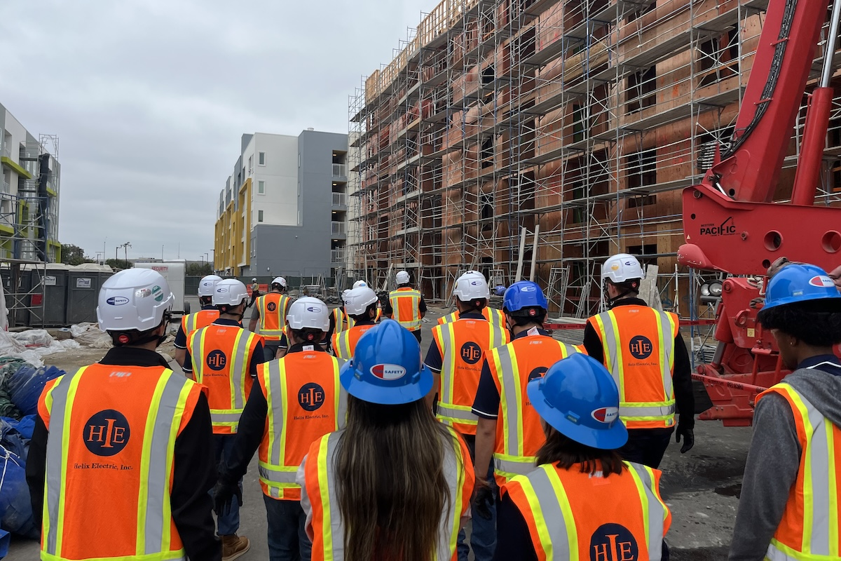 Summer interns at Helix Electric visit an active construction site to connect classroom learning with real-world applications.