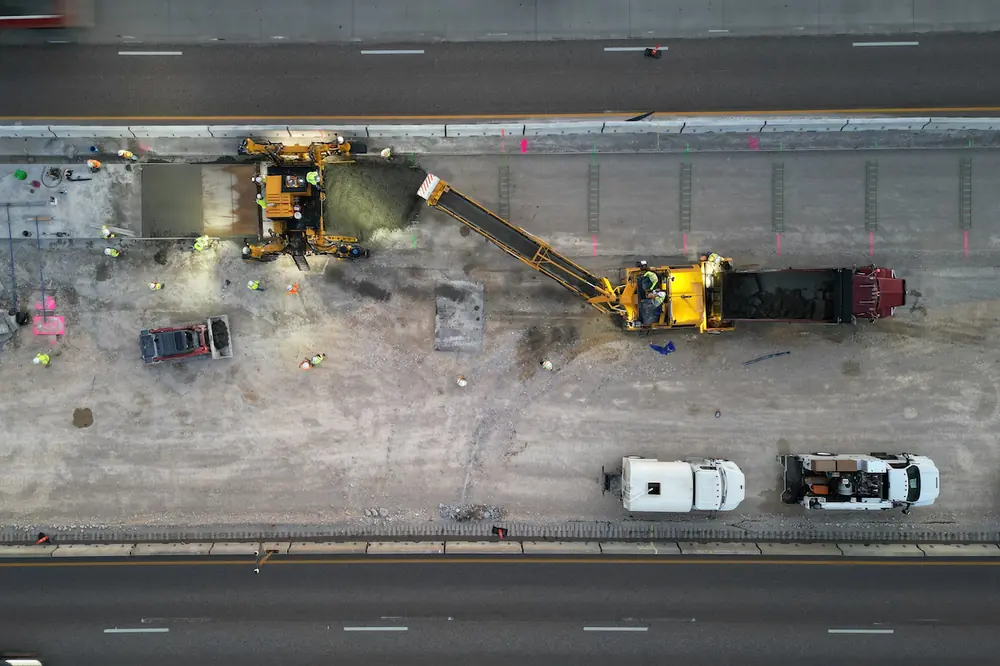 This aerial view shows crews surfacing portions of I-55 with a slipform paver.