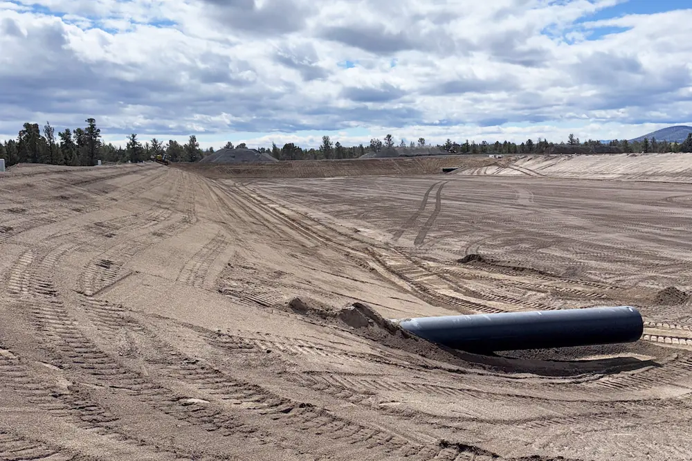 Bedding is prepared for the lagoon liner near the entrance of the internal recycle pipe at Lagoon 1. (Photo courtesy of Anderson Perry)