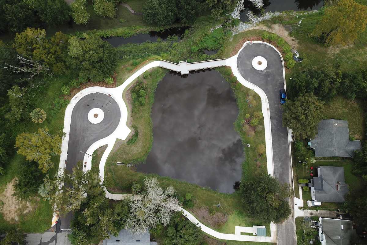 A retention pond and McCoys Creek Boulevard were replaced with new cul-de-sacs, a pedestrian bridge, and park features.