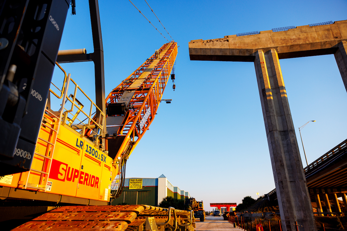 Superior Construction's Liebherr LR 1300.1 SX Crane is positioned for beam placement operations on the Brooks Bridge project in Fort Walton Beach, Florida.