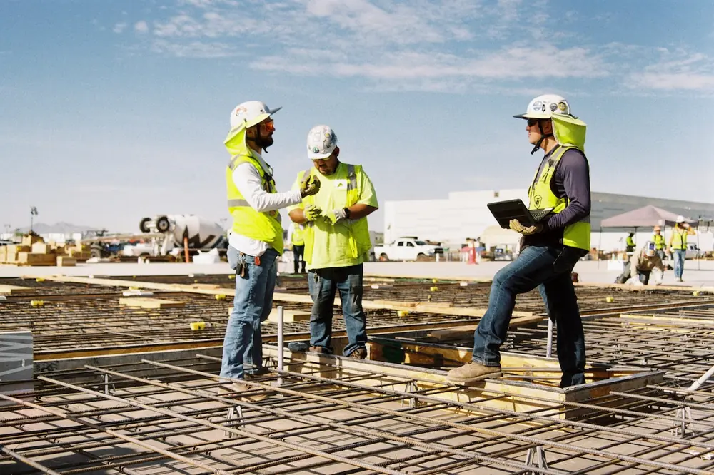 Teammates align on sequencing and next steps before a pour begins.