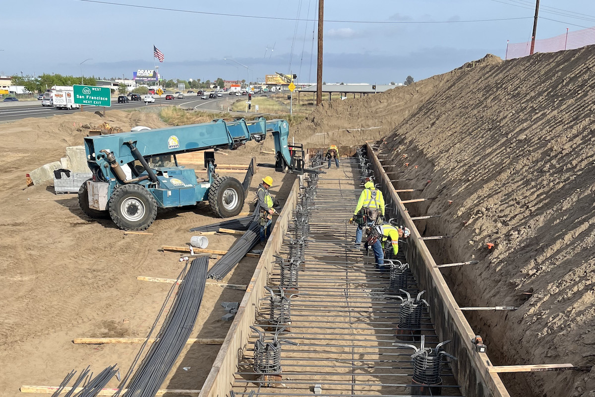 Work crews prepare the base of the supports of the new Austin Road overcrossing. The old bridge was removed to make room for a longer bridge to span added lanes to State Route 99 and Union Pacific Railroad tracks.