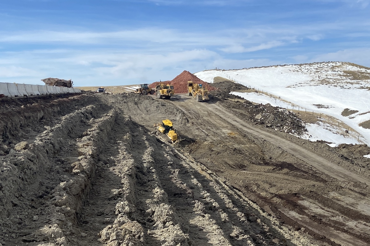 Contractors remove waste material from one of five slide locations on I-90. Once the waste material is removed, benches are cut into the slope in preparation for scoria to be placed.
