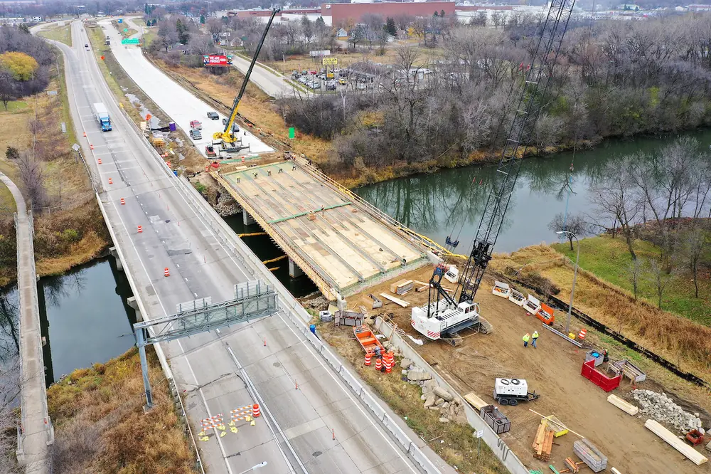 Work is performed on the eastbound I-90 Cedar River bridge in Austin, Minnesota.