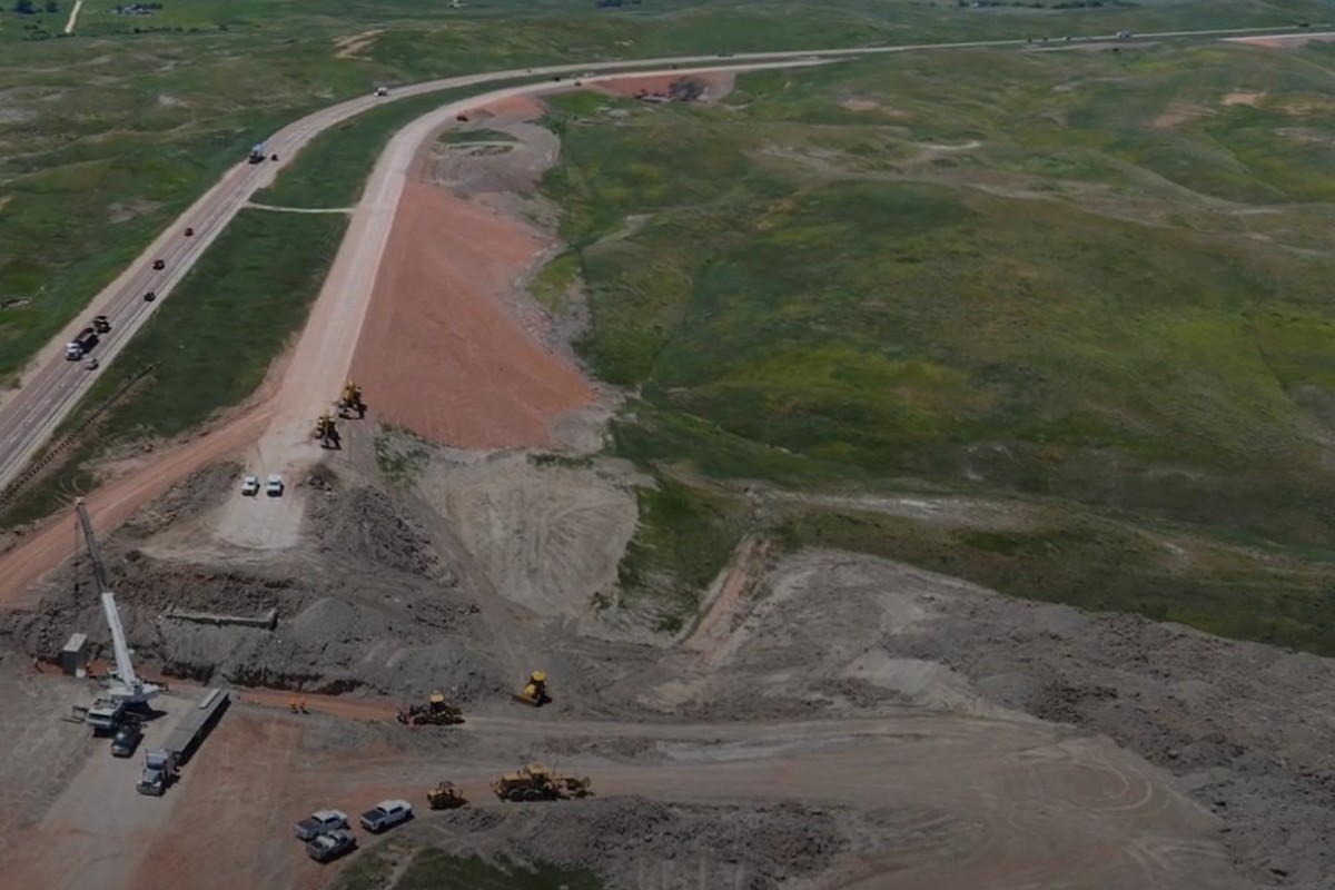Drone footage shows the I-90 project where a bridge is being replaced with a box culvert. Three of the five slide repair locations are seen in the background.