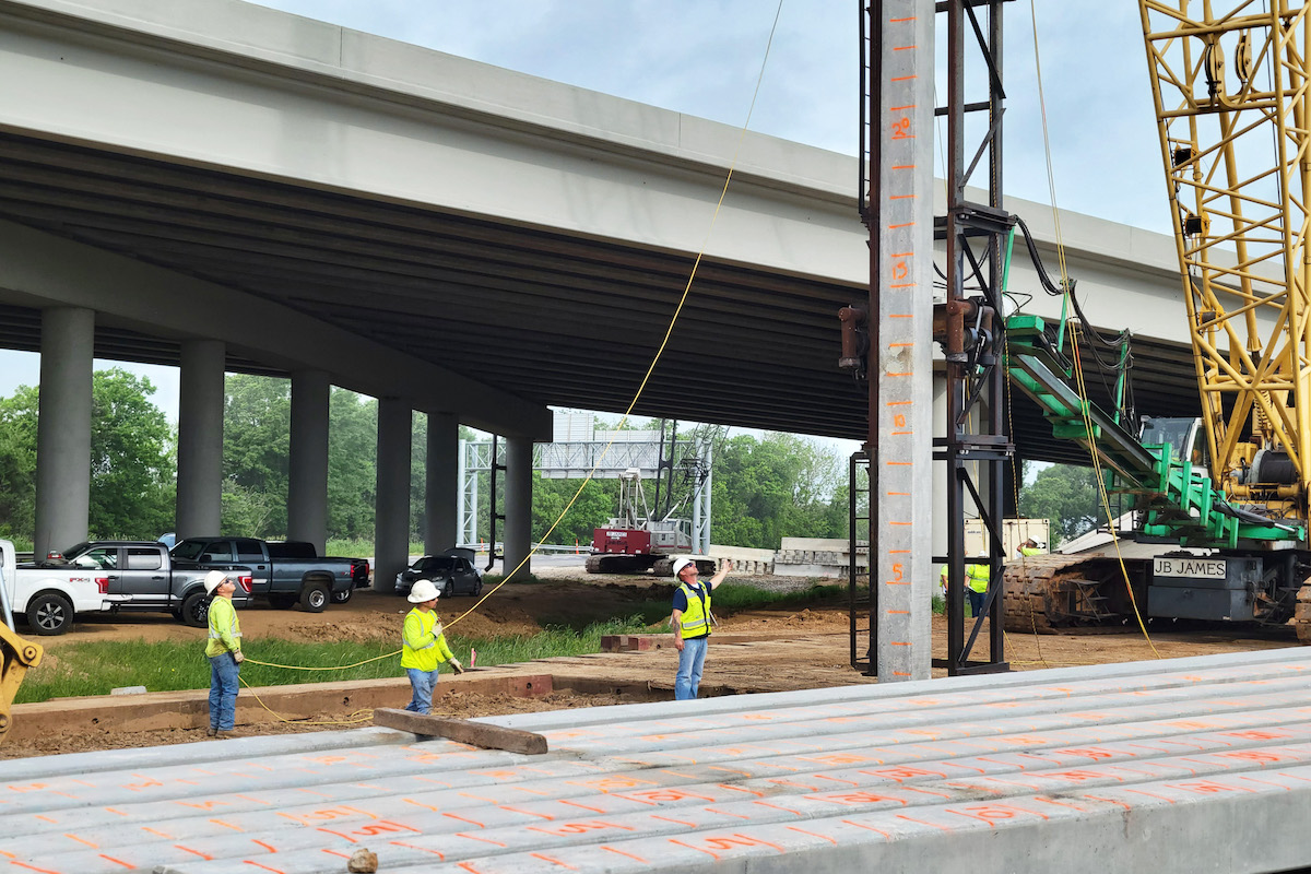 Crews set piles that will be driven for the BNSF railroad overpass.
