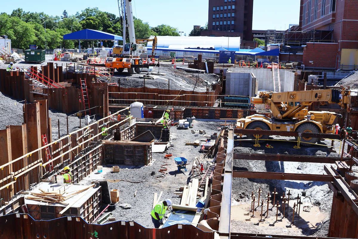 This snapshot shows the wide-ranging activity at the Strong Memorial Hospital expansion site. With piles in place, forms are being stripped while new ones are being constructed.