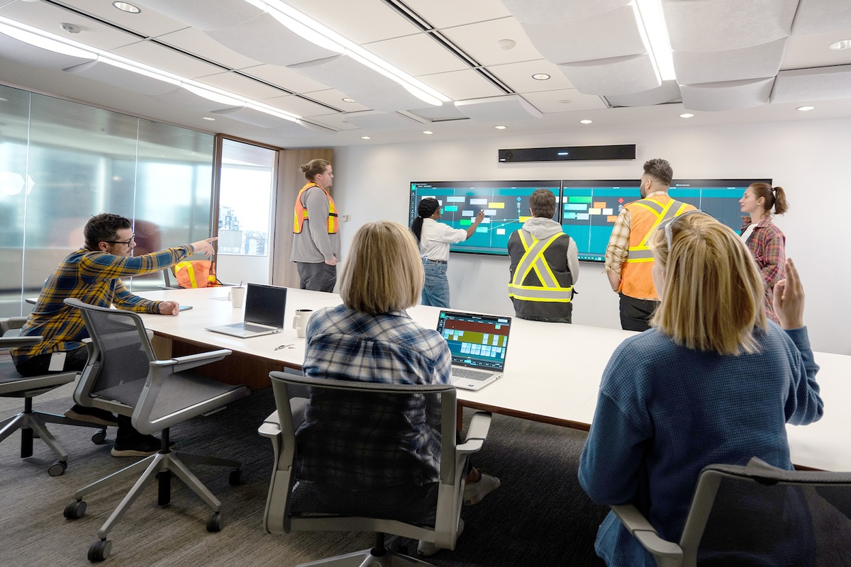 Lean planning allows everyone to collaborate in real time. Pictured here, teammates use Nialli Visual Planner on laptops while colleagues at the Nureva Wall interactive display update tasks.