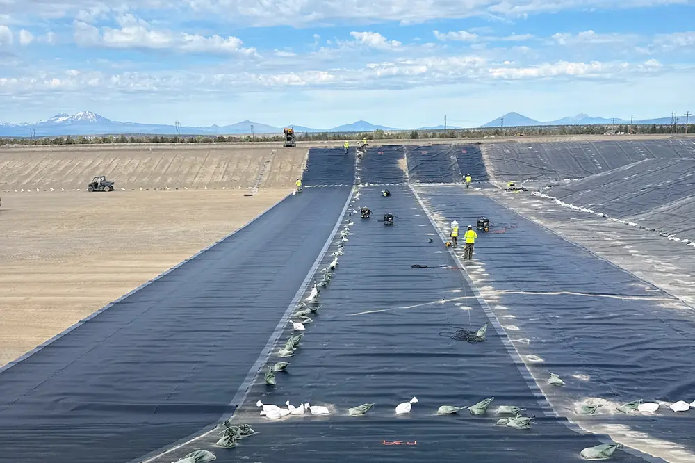 Liner installation progresses across the western portion of Lagoon 1 as crews prepare the lagoon for future treatment operations. (Photo courtesy of Anderson Perry)