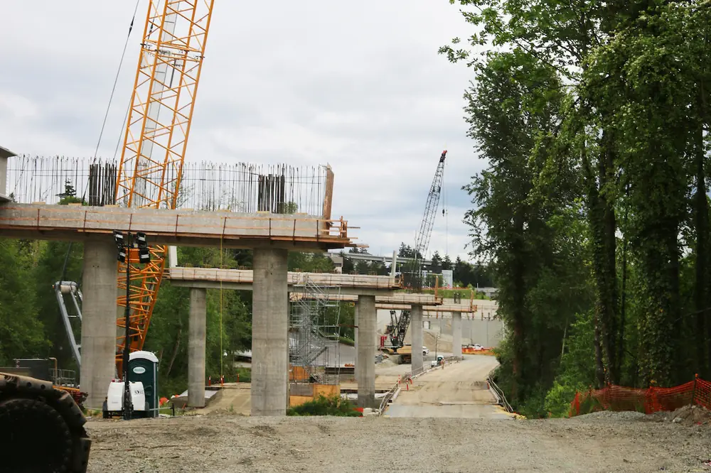 Crews use large cranes, like the Liebherr LR1300 Crawler Crane, to set 88 girders across nine bridge piers for the future SR 509 flagship bridge.